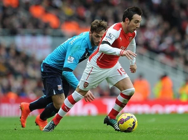 Arsenal's Santi Cazorla Fends Off Marko Arnautovic Challenge During Arsenal v Stoke City Premier League Clash