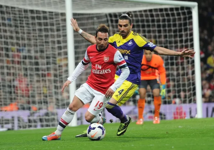 Framed Print : Arsenal's Santi Cazorla Fends Off Swansea's Chico Flores in Premier League Clash