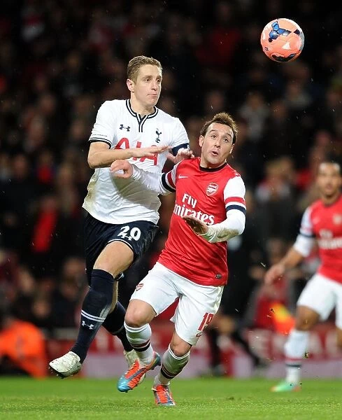 Arsenal's Santi Cazorla Holds Off Tottenham's Michael Dawson in FA Cup Clash