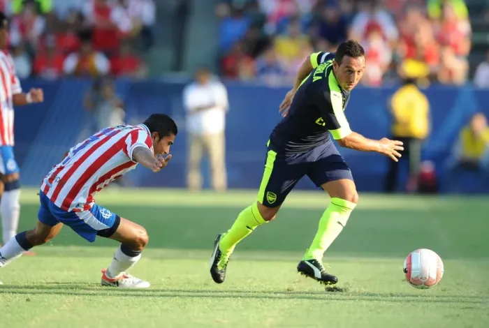 Framed Print : Arsenal's Santi Cazorla Outsmarts Orbelin Pineda in Pre-Season Showdown