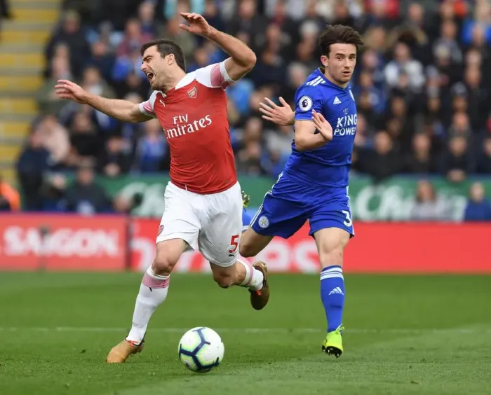 Framed Print : Arsenal's Sead Kolasinac Tripped by Leicester's Ben Chilwell in Intense Premier League Clash