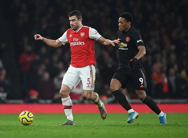 Arsenal's Sokratis Battles Past Manchester United's Anthony Martial in Premier League Clash