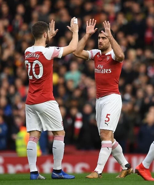 Arsenal's Sokratis and Mustafi Share a Moment Before the Arsenal v Tottenham Clash