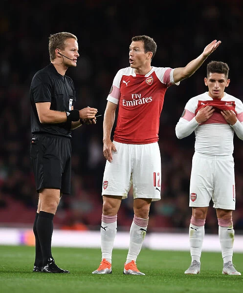Arsenal's Stephan Lichtsteiner Clashes with Referee Bart Vanyzere in Heated Europa League Match