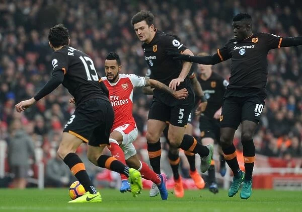 Arsenal's Theo Walcott Clashes with Hull Defenders during Premier League Match