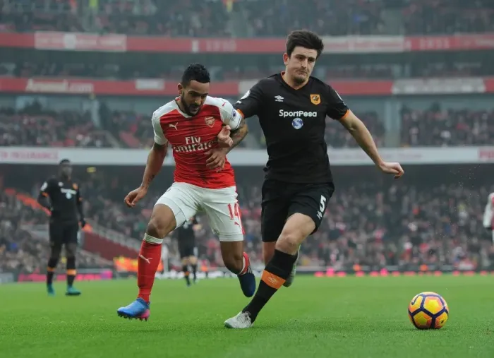 Framed Print : Arsenal's Theo Walcott Faces Off Against Hull's Harry Maguire in Premier League Clash Framed Print : Arsenal's Theo Walcott Faces Off Against Hull's Harry Maguire in Premier League Clash