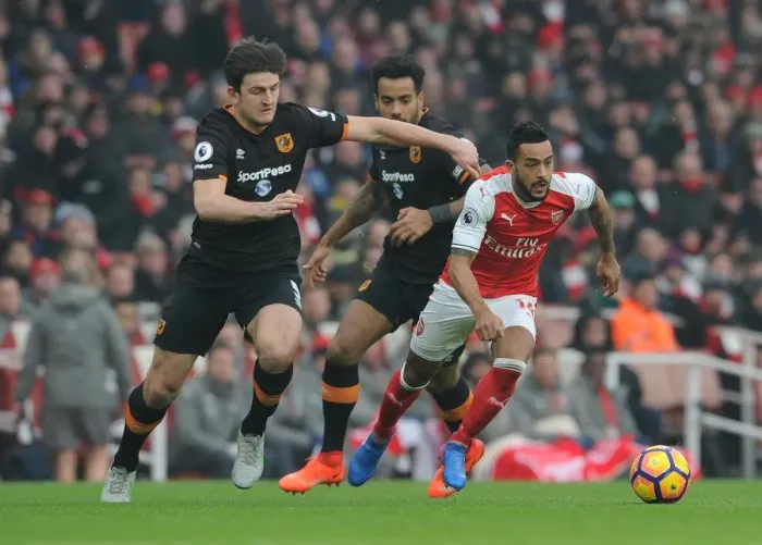 Framed Print : Arsenal's Theo Walcott Faces Off Against Hull's Maguire and Huddlestone in Intense Premier League Clash