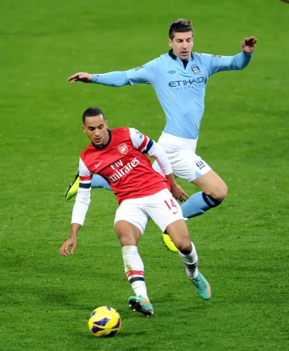 Framed Print : Arsenal's Theo Walcott Fends Off Manchester City's Matija Nastasic in Premier League Clash