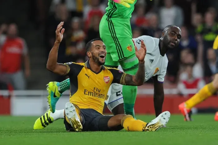 Framed Print : Arsenal's Theo Walcott vs. Eder Balanta: A Penalty Dispute in the UEFA Champions League Clash between Arsenal and FC Basel