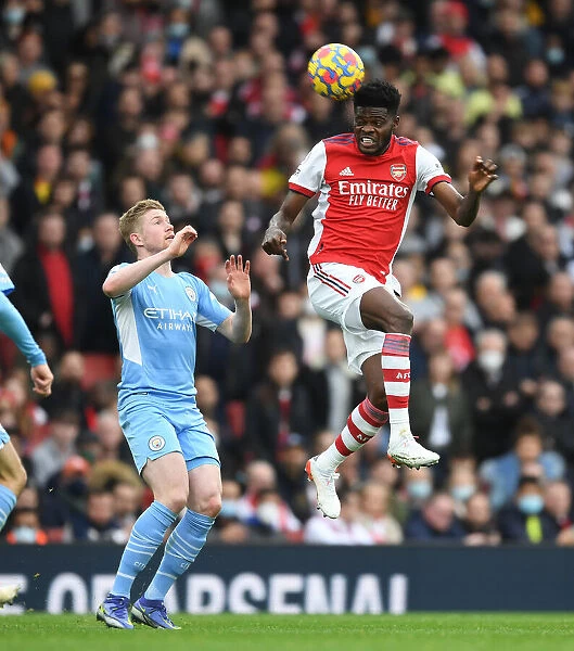 Arsenal's Thomas Partey Soars Above Manchester City's Kevin De Bruyne in Intense Premier League Clash