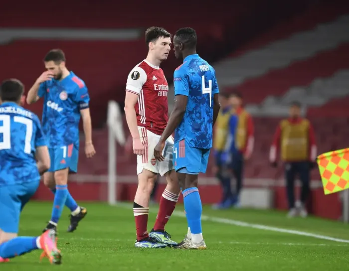 Framed Print : Arsenal's Tierney Goes Head-to-Head with Camara in Empty Europa League Clash, London, 2021
