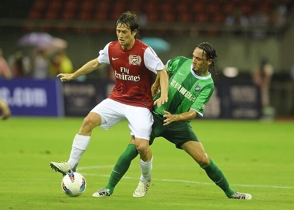 Arsenal's Tomas Rosicky Faces Off Against Vazquez in Hangzhou Friendly