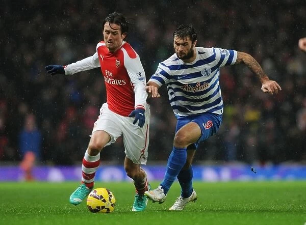 Arsenal's Tomas Rosicky Outmaneuvers QPR's Charlie Austin during the 2014-15 Premier League Match