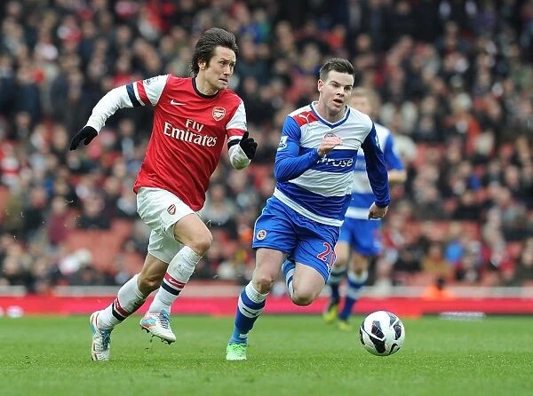 Arsenal's Tomas Rosicky Outmaneuvers Reading's Danny Guthrie during the Premier League Match
