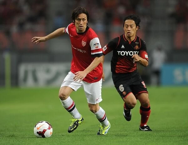 Arsenal's Tomas Rosicky Outruns Nagoya Grampus's Shohei Abe during 2013 Pre-Season Match