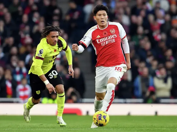 Framed Print : Arsenal's Tomiyasu Fends Off Burnley's Koleosho: Premier League Clash at Emirates Stadium (2023-24)