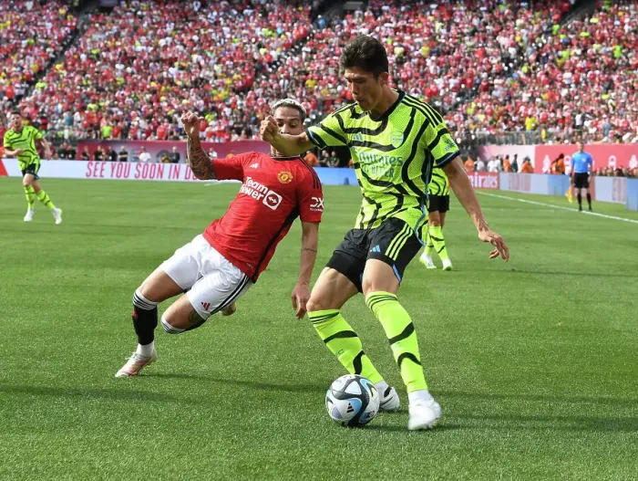 Framed Print : Arsenal's Tomiyasu Goes Head-to-Head with Manchester United's Antony in Pre-Season Showdown