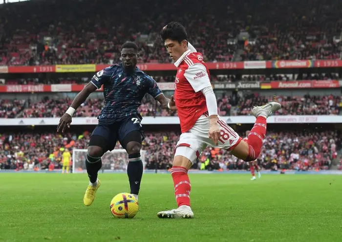 Framed Print : Arsenal's Tomiyasu Outmaneuvers Aurier in Premier League Clash vs. Nottingham Forest Framed Print : Arsenal's Tomiyasu Outmaneuvers Aurier in Premier League Clash vs. Nottingham Forest