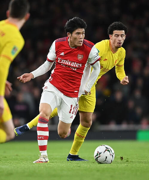 Arsenal's Tomiyasu Stuns Liverpool's Jones in Intense Carabao Cup Semi-Final Tackle