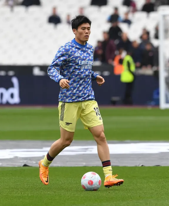 Framed Print : Arsenal's Tomiyasu Warms Up Ahead of West Ham Clash in Premier League