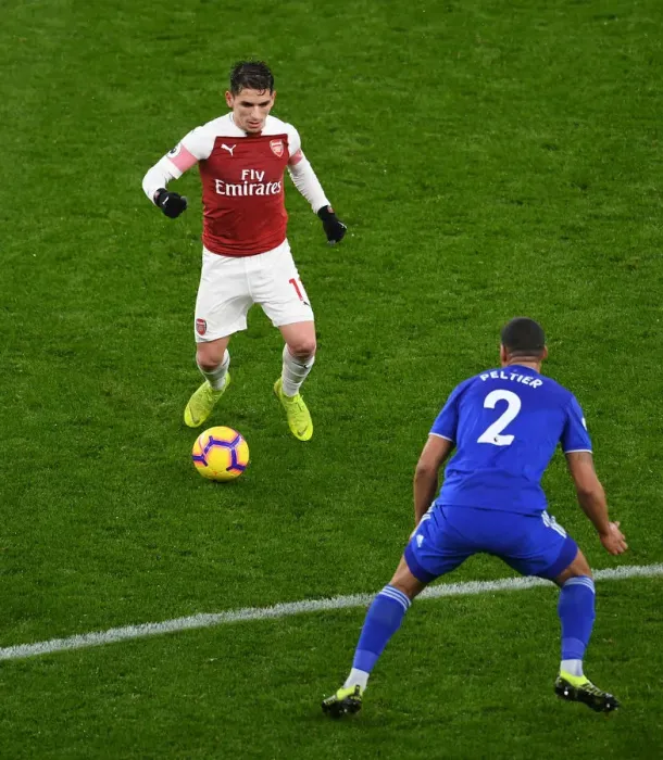 Framed Print : Arsenal's Torreira Clashes with Cardiff's Peltier in Premier League Showdown