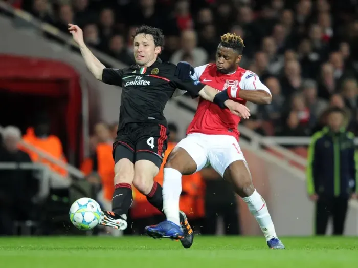 Framed Print : Arsenal's Triumph: 3-0 Over AC Milan - The Unforgettable Clash Between Alex Song and Mark van Bommel in the UEFA Champions League