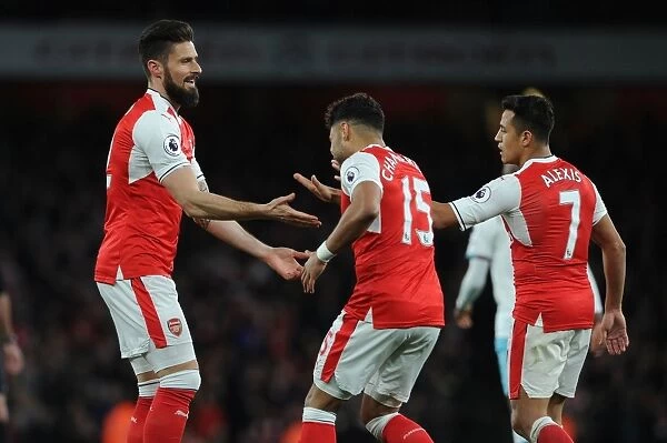 Arsenal's Triumph: Giroud, Oxlade-Chamberlain, and Sanchez Celebrate Goals Against West Ham United