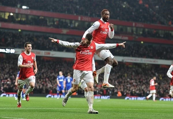 Arsenal's Triumph: Koscielny, Djourou, and Fabregas Celebrate Second Goal in Carling Cup Semi-Final Victory