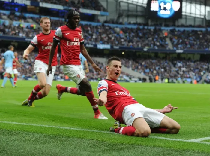 Framed Print : Arsenal's Triumph: Koscielny, Mertesacker, and Gervinho Celebrate Goal Against Manchester City (2012-13) Framed Print : Arsenal's Triumph: Koscielny, Mertesacker, and Gervinho Celebrate Goal Against Manchester City (2012-13)