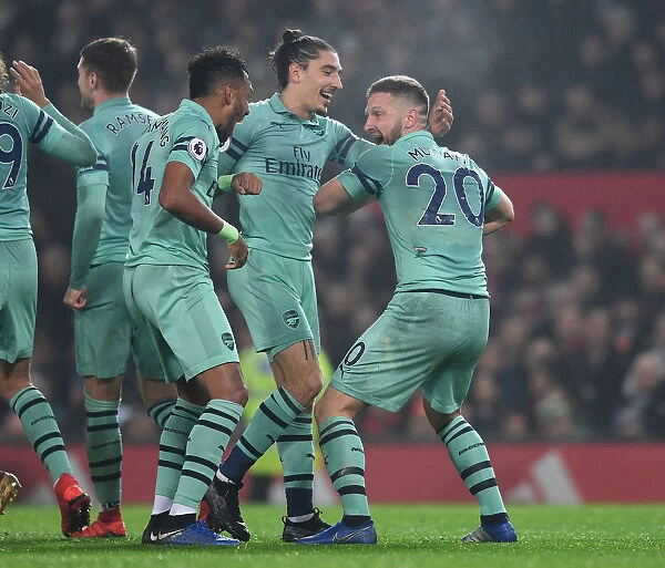 Arsenal's Triumph: Mustafi, Aubameyang, and Bellerin Celebrate First Goal vs. Manchester United (2018-19)