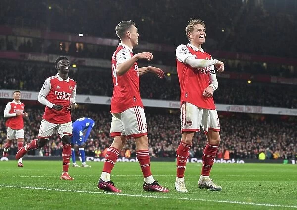 Arsenal's Triumph: Odegaard and Trossard Celebrate Third Goal Against Everton (2022-23)