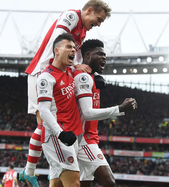 Arsenal's Triumph: Partey, Martinelli, and Odegaard Celebrate Goal Against Leicester City
