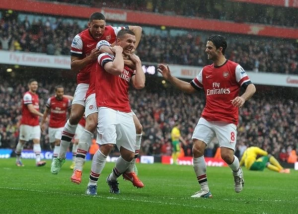 Arsenal's Triumph: Podolski, Oxlade-Chamberlain, and Arteta Celebrate Goals Against Norwich City (2012-13)