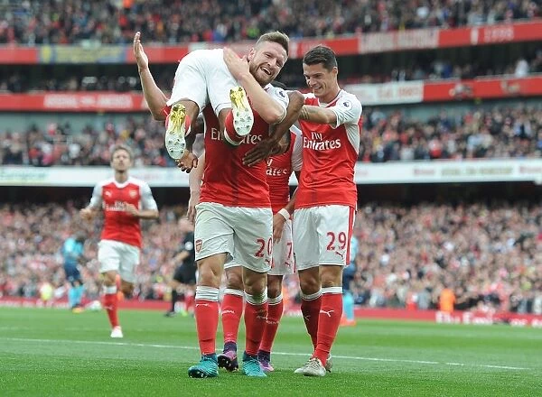 Arsenal's Triumph: Walcott, Mustafi, and Xhaka Celebrate Goals Against Swansea City (2016-17)