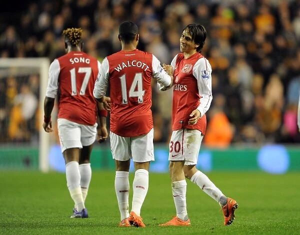 Arsenal's Triumphant Third Goal: Benayoun and Walcott Celebrate Victory over Wolverhampton Wanderers (2011-12)