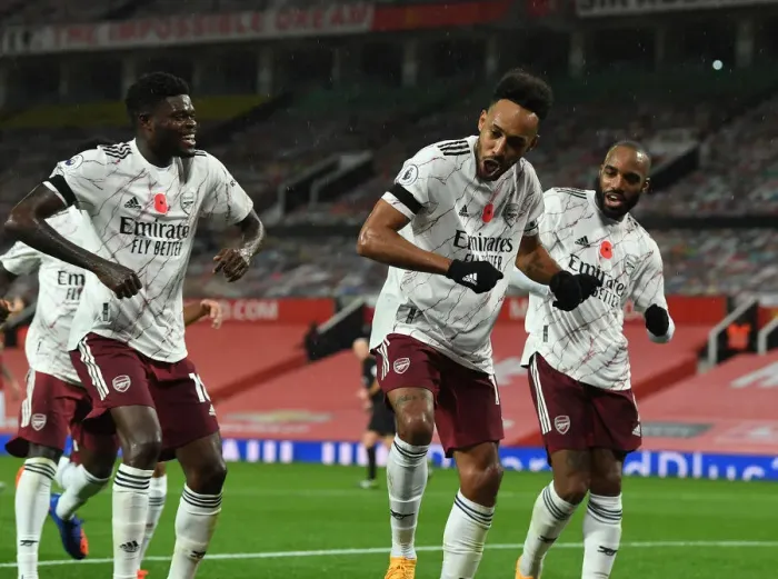 Framed Print : Arsenal's Triumphant Three: Aubameyang, Partey, Lacazette Celebrate Goal at Empty Old Trafford (2020-21)