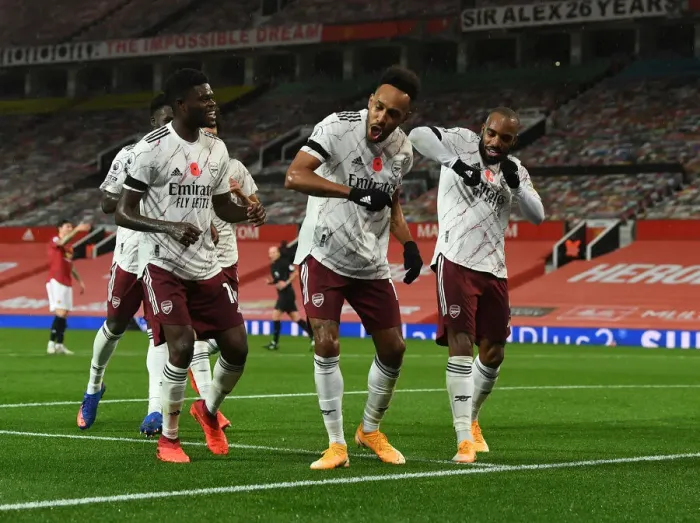 Framed Print : Arsenal's Triumphant Threesome: Aubameyang, Partey, Lacazette Celebrate Goal at Empty Old Trafford (2020-21)