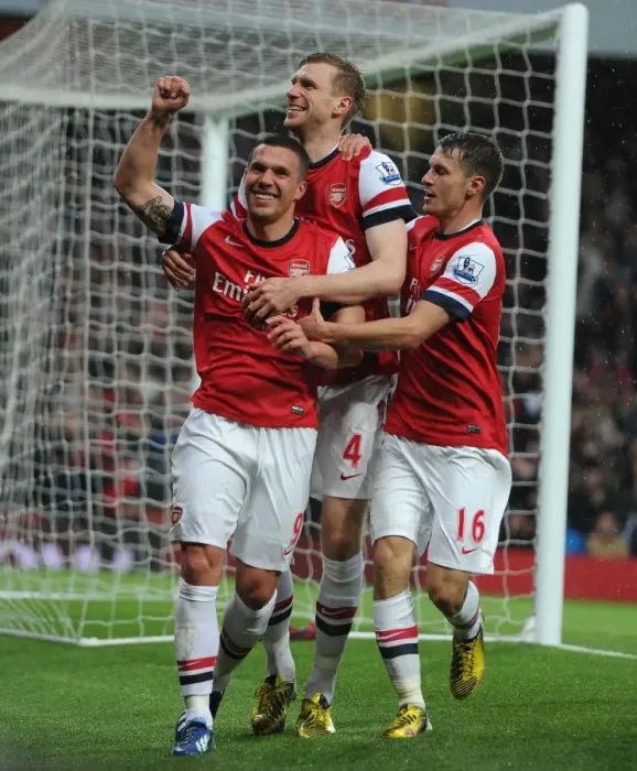Framed Print : Arsenal's Triumphant Trio: Podolski, Mertesacker, and Ramsey's Euphoric Goal Dance (2012-13)