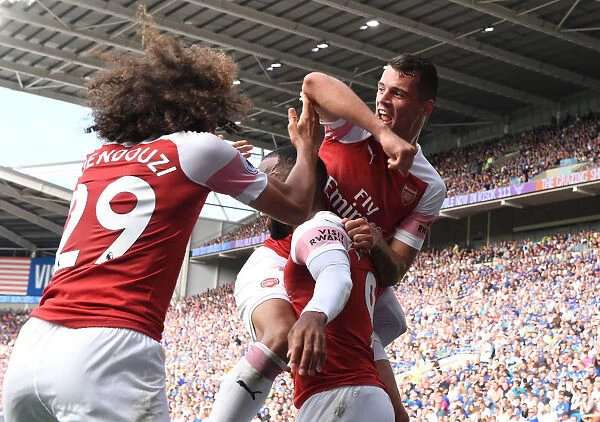 Arsenal's Triumphant Trio: Xhaka, Lacazette, Guendouzi's Jubilant Celebration Against Cardiff City