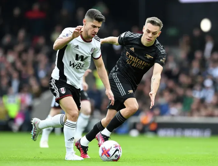 Framed Print : Arsenal's Trossard Closes In on Fulham's Solomon in Premier League Clash