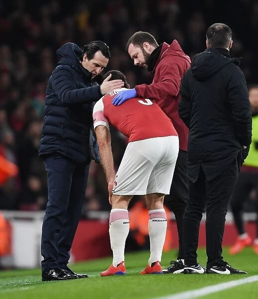 Arsenal's Unai Emery Consoles Injured Sokratis Amidst Arsenal v Manchester United FA Cup Clash