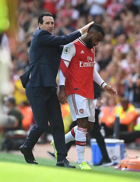Arsenal's Unai Emery Consoles Substituted Lacazette After Arsenal v Burnley Match