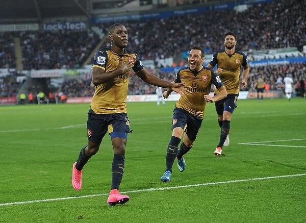 Arsenal's Unstoppable Duo: Campbell and Cazorla Celebrate Their Third Goal vs Swansea City (2015-16)