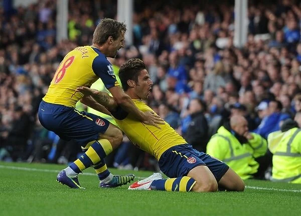 Arsenal's Unstoppable Duo: Giroud and Monreal Celebrate Victory over Everton in the Premier League 2014 / 15