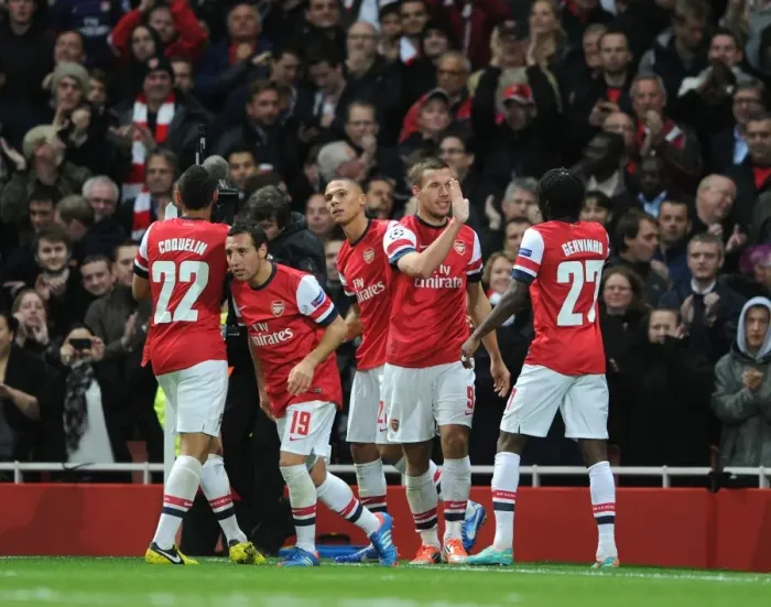 Framed Print : Arsenal's Unstoppable Duo: Podolski and Gervinho Celebrate 2-1 Over Olympiacos in Champions League