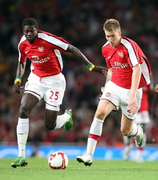 Arsenal's Unstoppable Strike Force: Bendtner and Adebayor in Action against FC Twente (4-0)