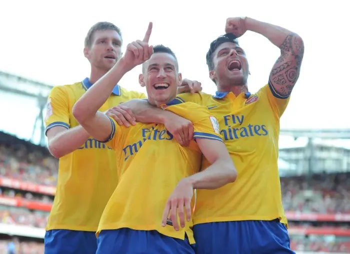 Framed Print : Arsenal's Unstoppable Trio: Koscielny, Mertesacker, and Giroud's Unforgettable Goal Celebration (2013-14 Emirates Cup)