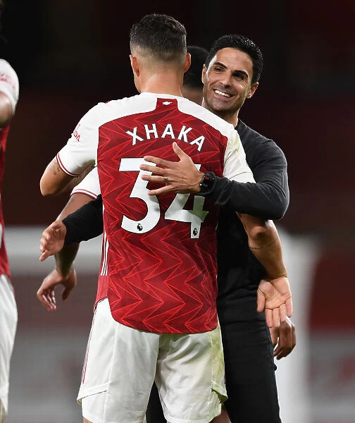 Arsenal's Victory: Mikel Arteta Embraces Granit Xhaka after Arsenal v West Ham United (2020-21)