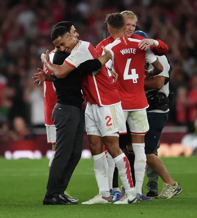 Framed Print : Arsenal's Victory: Mikel Arteta Embraces William Saliba after Beating Manchester City (2023-24)