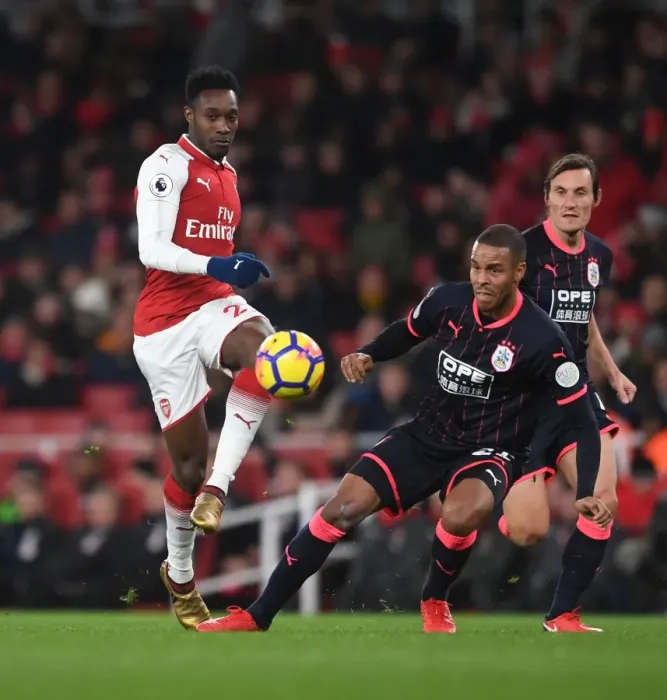 Framed Print : Arsenal's Welbeck Faces Off Against Huddersfield's Jorgensen in Premier League Clash
